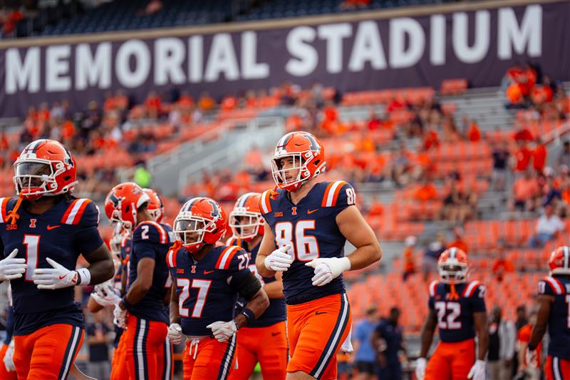 Christian Abney, Gies students and Fighting Illini player with other players at Gies Memorial Stadium